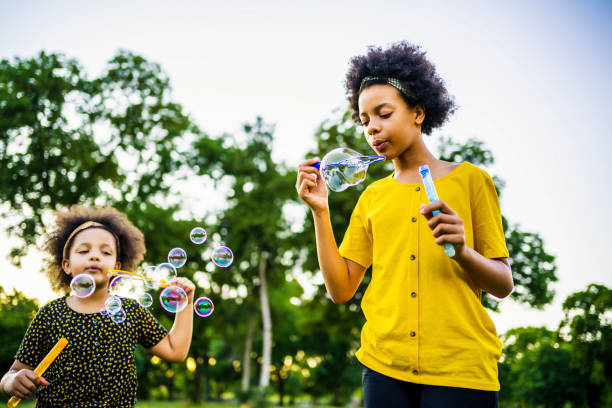 istock Sisters blowing bubbles outdoors 1337044209