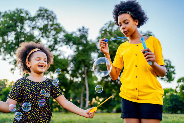 istock Sisters blowing bubbles outdoors 1337044857