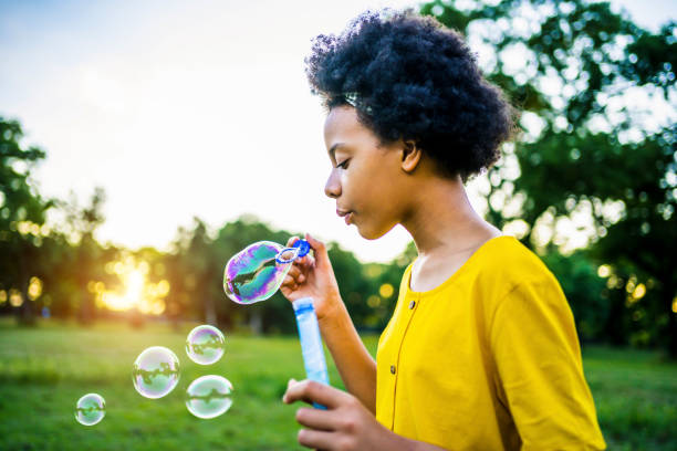 istock Girl blowing bubbles outdoors 1337044942