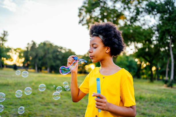 istock Girl blowing bubbles outdoors 1337044980