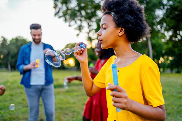 istock Girl blowing bubbles outdoors 1337045050