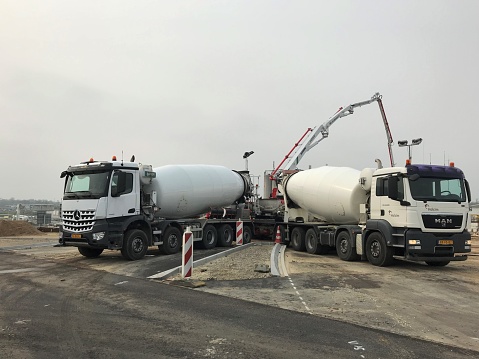 concrete mixer truck at the Main street in Luckenburg on the way to the construction site