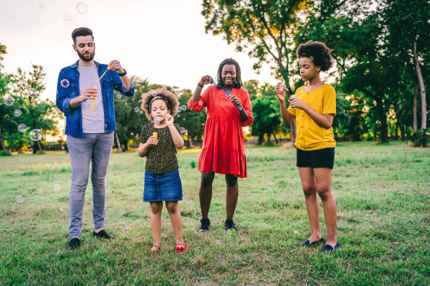 istock Cheerful family blowing bubbles together 1337045227