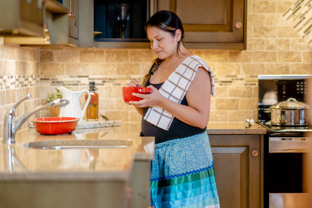 istock Indigenous female adult preparing a meal at home 1337046830