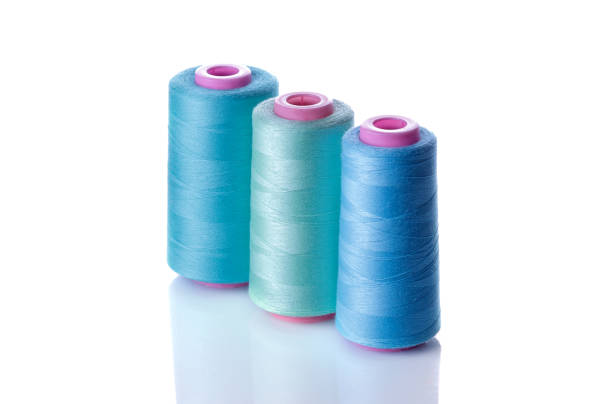 istock A bobbin with threads in blue tones on a white isolated background. accessories for sewing 1337048020