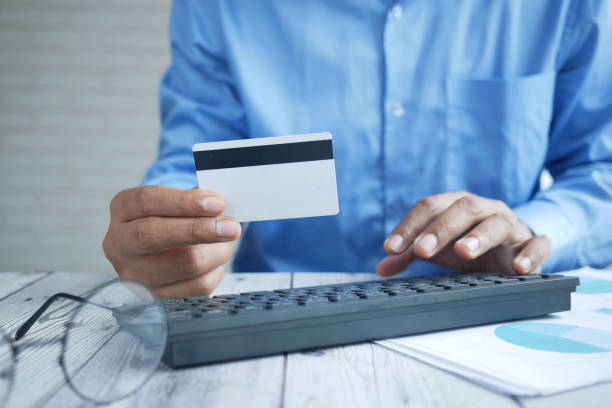 istock man hands holding credit card and using laptop shopping online 1337049086