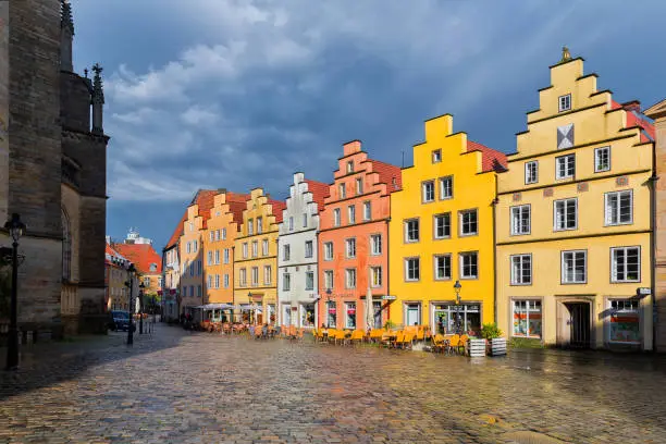 Photo of Osnabrück, Lower Saxony, Germany, June 5, 2021. St. Marien church and facedes of old houses on the Market square in the historical center of Osnabrück