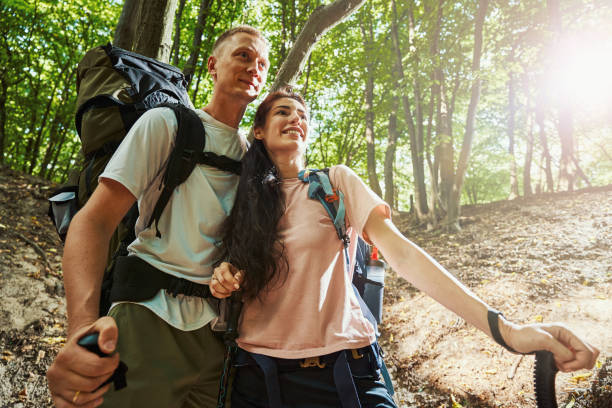 istock Joyful young people in love hiking in forest 1337058641