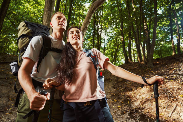 istock Jolly young couple enjoying landscape among trees 1337058652