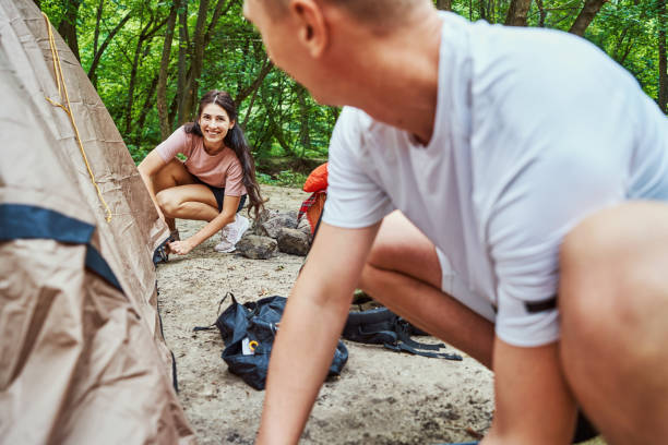istock Happy couple preparing for romantic weekend in camp 1337060972