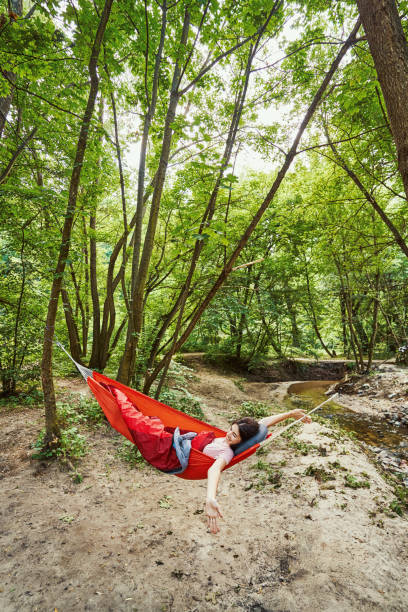 istock Joyful young woman relaxing in green forest 1337060997