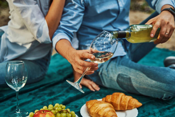 istock Happy romantic couple on picnic with wine 1337061026