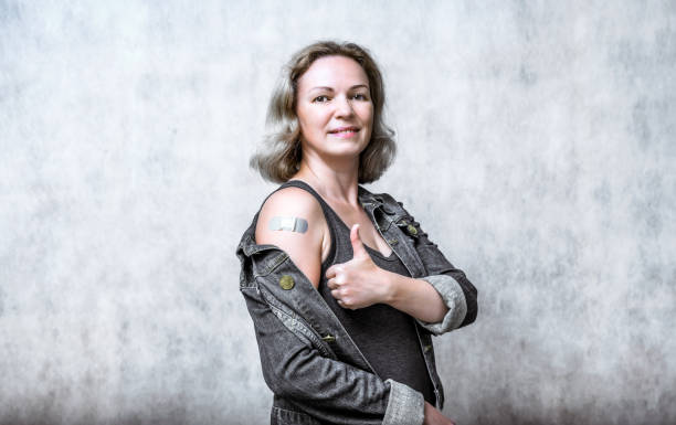 istock COVID-19 vaccinated young woman showing arm with plaster 1337062884