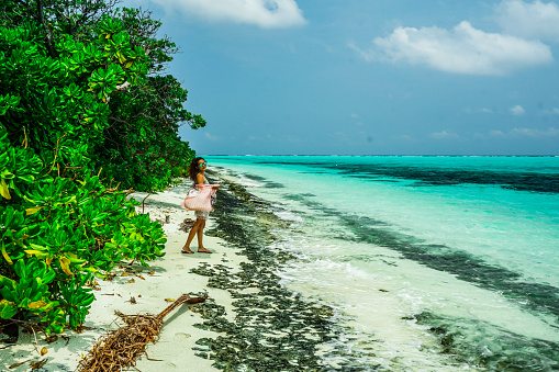 Beautiful beach turquoise ocean water and blue sky with clouds in sunny day.