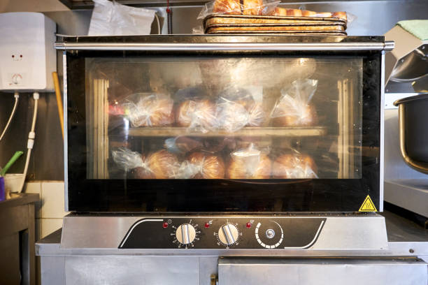istock Industrial small size bread oven with cooked breads in a restaurant bakery kitchen 1337067291
