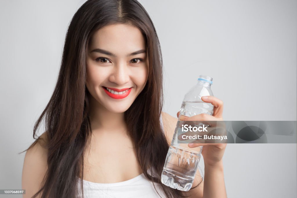 Young Beautiful Asian Woman With Smiley Face And Red Lips Holding A Water  Bottle Stock Photo - Download Image Now - iStock