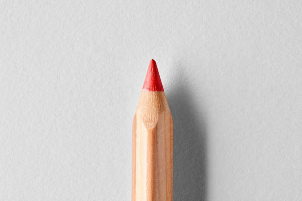 istock Red wooden crayon pencil on white background. Close up macro view 1337068684
