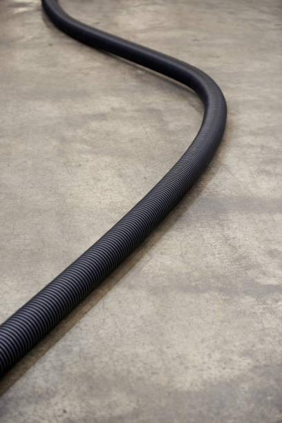 istock Corrugated plastic pipe for insulating electrical wires, on a concrete floor 1337070127
