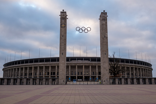 Berlin, Germany - February 23, 2010: Monumental Olympic Stadium (Olympiastadion) in Berlin under bright blue sky, which was built for the 1936 Summer Olympics. On the image is the main entrance.