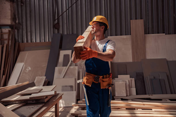 istock Handsome young man carrying wooden plank at construction site 1337071604