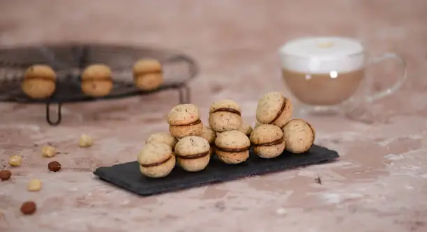 Photo of Baci di dama homemade italian hazelnut biscuits cookies with chocolate.