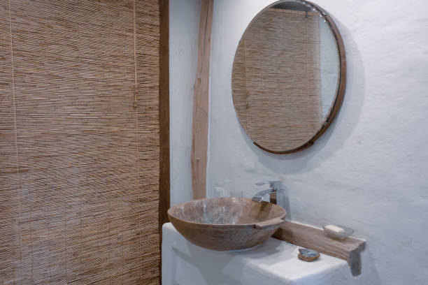 istock Loft style bathroom with washbasin and round mirror 1337074220