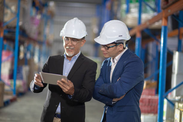istock Asian Chinese management having discussion at warehouse with white hardhat using digital tablet 1337078081
