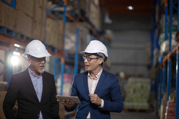 istock Asian Chinese management having discussion at warehouse with white hardhat using digital tablet 1337078147