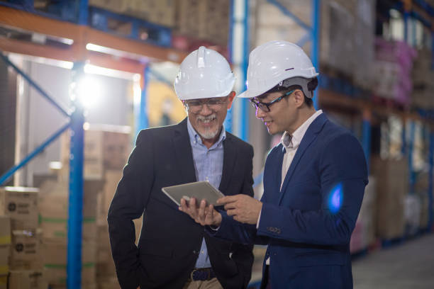 istock Asian Chinese management having discussion at warehouse with white hardhat using digital tablet 1337078161