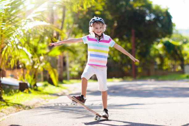 istock Kid with skateboard. Child riding skate board. 1337078190