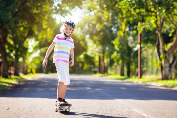 istock Kid with skateboard. Child riding skate board. 1337078222