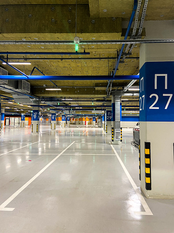 An empty parking space with a number in the underground parking of the shopping center