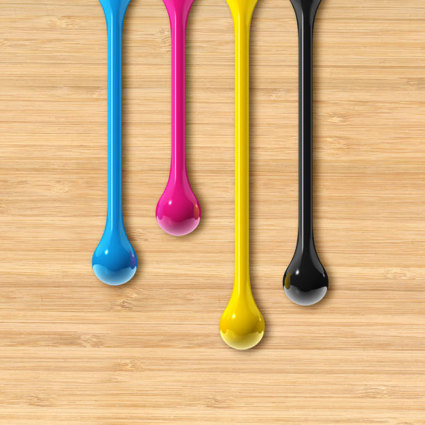 istock cmyk ink drops on beige wooden square background 1337082975