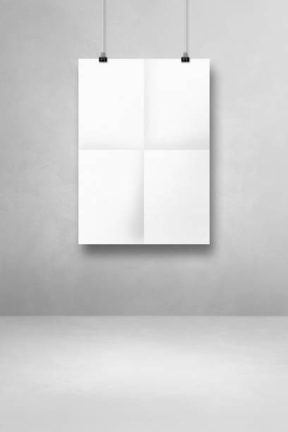 istock White folded poster hanging on a clean wall with clips 1337083295