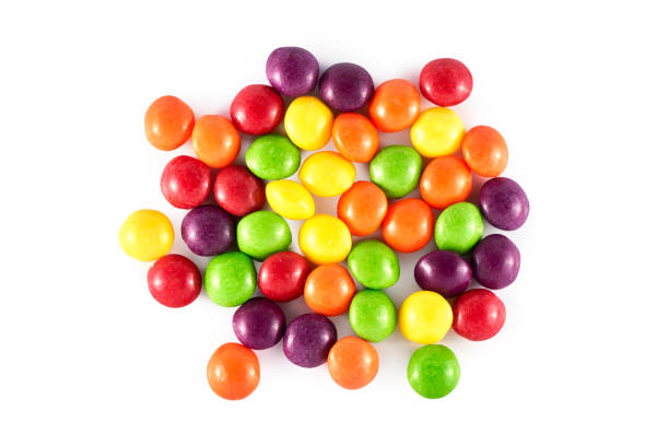 istock Heap of colored round dragee sweets isolated on white background, top view, flat lay. Multicolored
