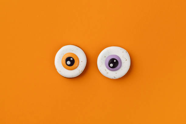 Halloween homemade gingerbread on orange background with copy space. Top view flat lay halloween party celebration concept
