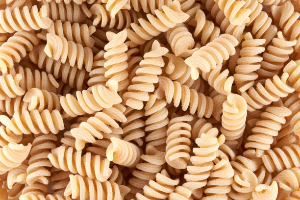 istock spiral noodles close up background, pasta and macaroni 1337084391