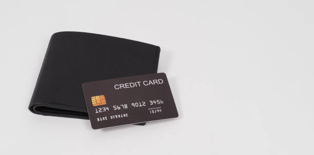 istock Black Credit card on wallet isolated on white background. 1337085093