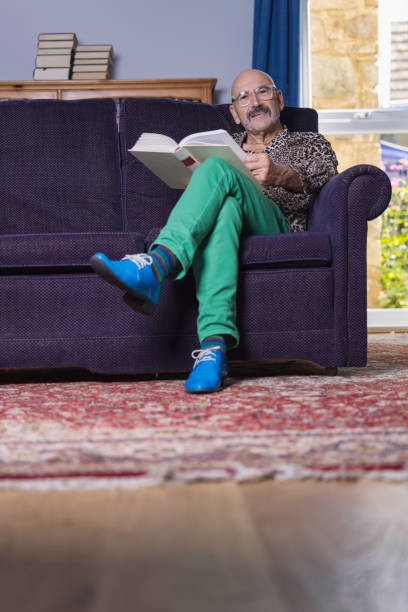 istock Senior gay man reading in his study 1337086425