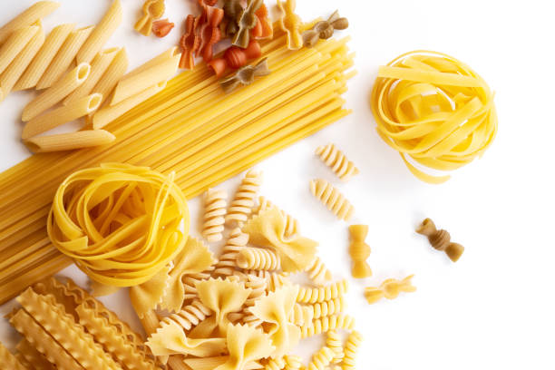 istock Assorted varieties of pasta wallpaper. Mix macaroni, spaghetti on white background 1337087125