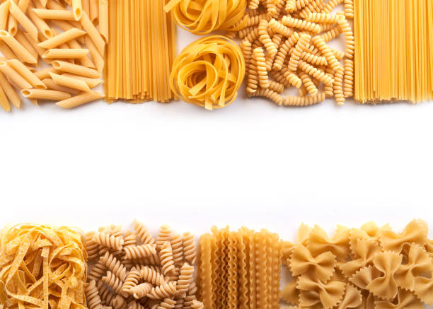 istock Frame from Assorted varieties of pasta wallpaper. Mix macaroni, spaghetti on white background with copy space 1337087136