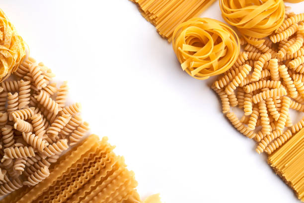 istock Frame from Assorted varieties of pasta wallpaper. Mix macaroni, spaghetti on white background with copy space 1337087152