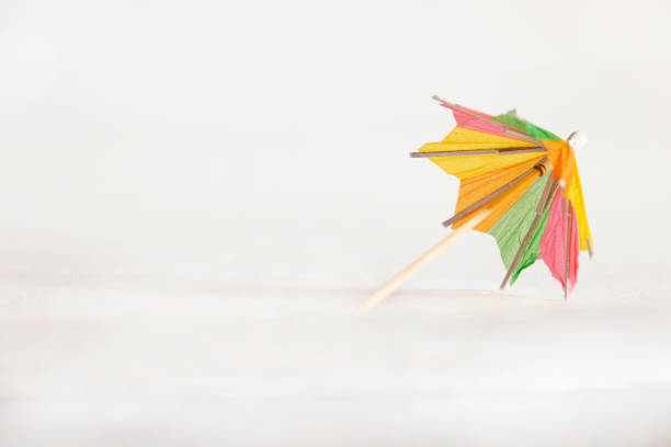 This is an umbrella in shape of orange fresh fruit with drop of juice.