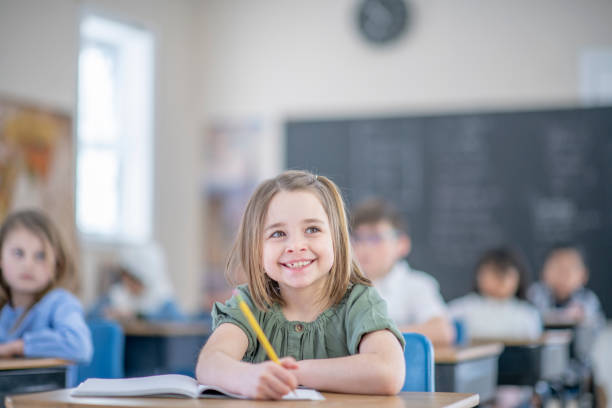 istock Elementary school girl happy to be back in the classroom 1337091103