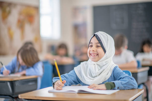 istock Smiling Muslim school girl in an elementary classroom 1337091106