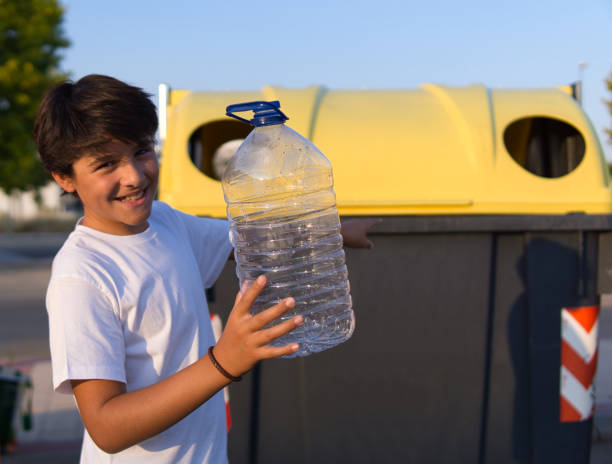 istock Boy pointing to where to throw plastic bottle 1337093867