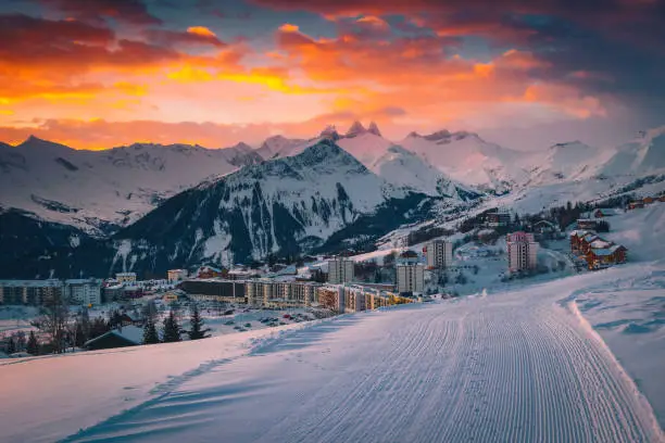 Photo of Popular alpine ski resort with colorful sunrise, La Toussuire, France