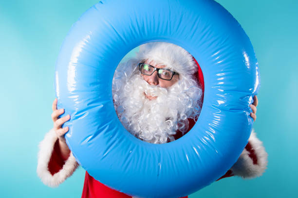 istock Rest. Funny Santa Claus with a rubber ring. 1337096998