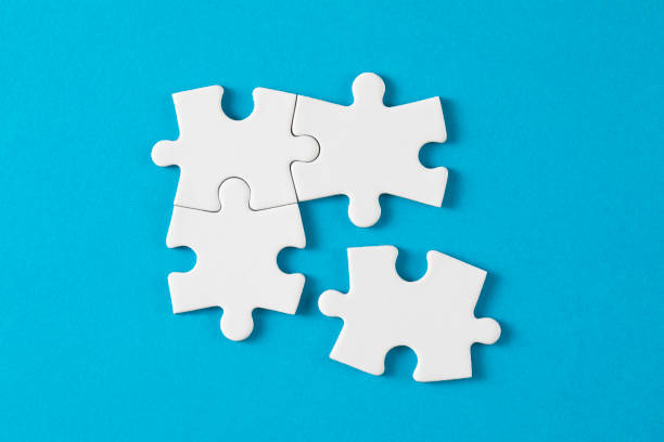 connection concept with white puzzle pieces - puzzel stockfoto's en -beelden