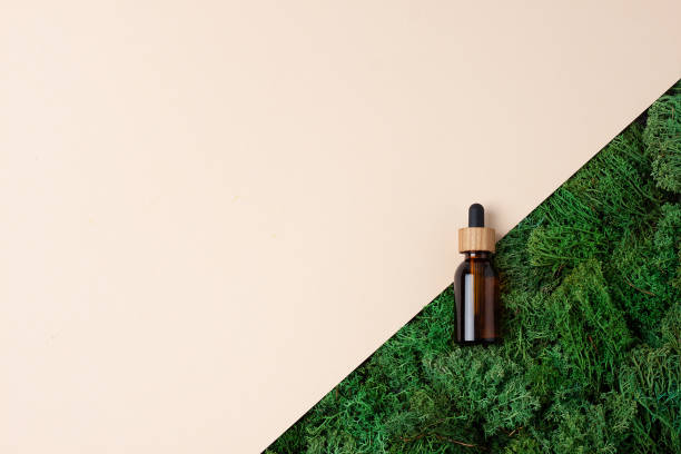 istock Cosmetic bottle with moss on beige background. Flat lay, copy space. 1337098465